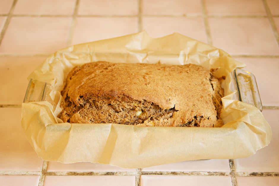 A loaf of banana bread in a tin, sliced