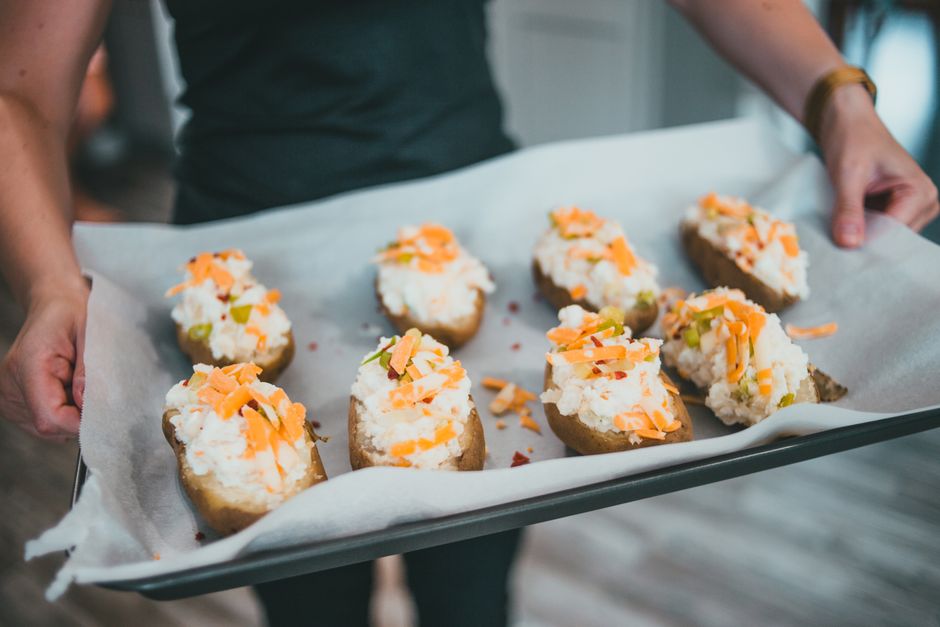 Loaded baked potatoes on a tray