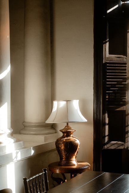 A warm lamp on a wooden table in a cosy interior